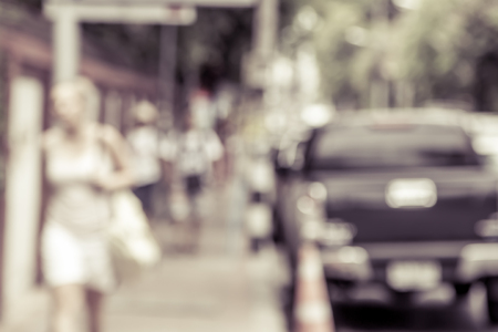 blur image of people walking on sidewalk beside road,vintage filterの写真素材