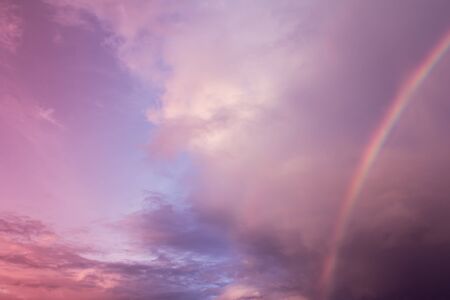 rainbow with cloudy on sky,purple color filter effectの写真素材