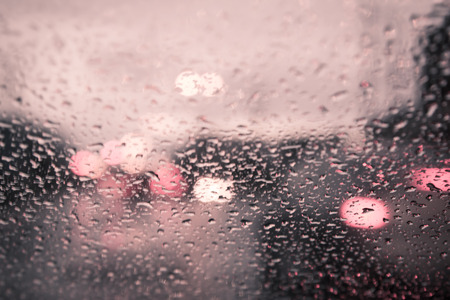 blurred image of traffic view through a car windscreen covered in rain,vintage filterの写真素材