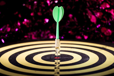 Success hitting target aim goal achievement. Dart in target center on dartboard, vintage effect...