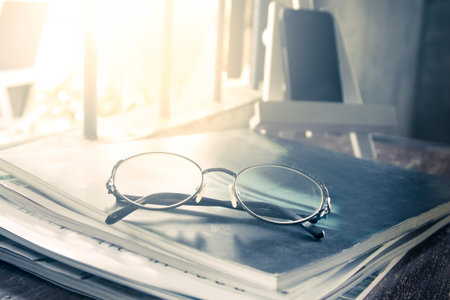 glasses on magazine in vintage color tone