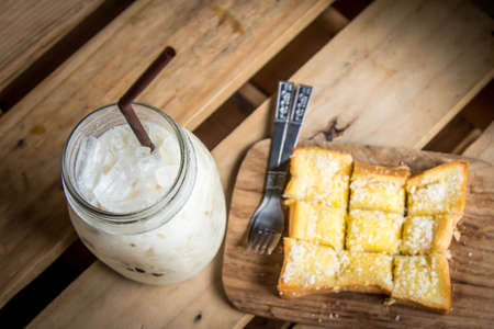 top view of milk with sweet toast on wooden tableの写真素材