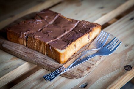 Chocolate sweet toast with fork on wooden tableの写真素材
