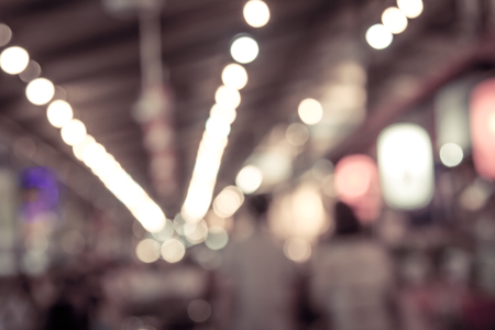 blurred restaurant in public market with bokeh in vintage color toneの写真素材