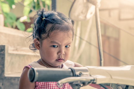 upset little girl in outdoor in vintage color toneの写真素材