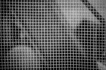 abstract background of steel grid mesh in black and whiteの写真素材