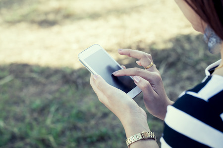 Woman hand use smart phone, tablet,cellphone,phone in vintage color toneの写真素材