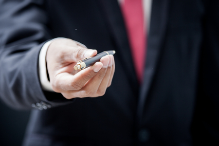 Focus on pen smart businessman giving penの写真素材