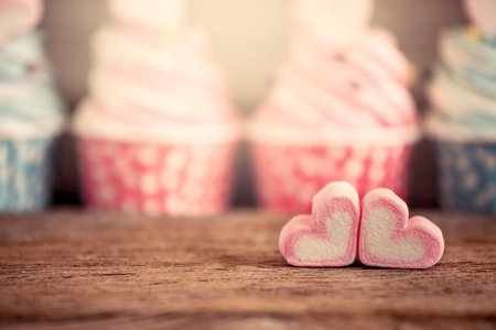 Sweet heart shape of marshmallow on wooden table in vintage color toneの写真素材