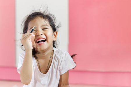 Happy asian little girl is laughingの写真素材