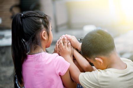 Children holding hand s and playing together in the park in vintage color toneの写真素材