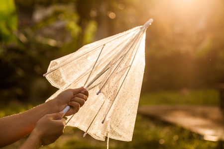 Woman hand close and keep an umbrella after rain in vintage color toneの写真素材