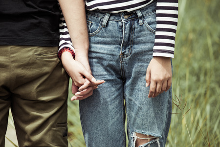 Young love couple holding hands together in vintage color toneの写真素材