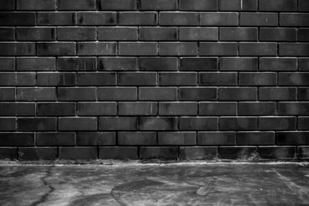 Room interior concrete floor and  black brick wall texture for backgroundの写真素材