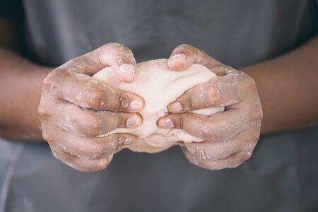 Woman hands kneading dough prepare for baking cookies in the kitchenの写真素材
