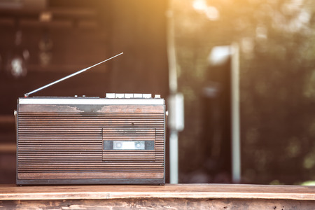 Retro radio cassette stereo on wooden table in vintage color toneの写真素材