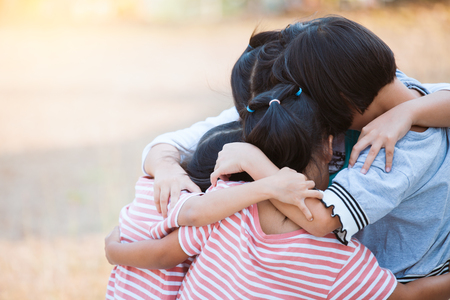 Group of asian children hugging and playing together with love and fun in the parkの写真素材