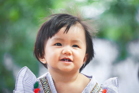 Cute asian baby girl playing with her toy with happinessの写真素材