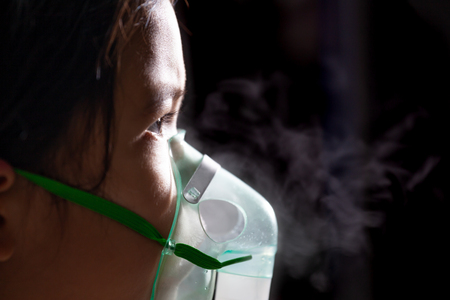 Asian child girl has asthma or pneumonia disease and need nebulization by get inhaler mask on her faceの写真素材