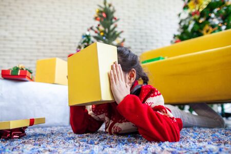 Cute asian child girl surprise with gift and holding beautiful gift box in hand on Christmas celebrationの写真素材