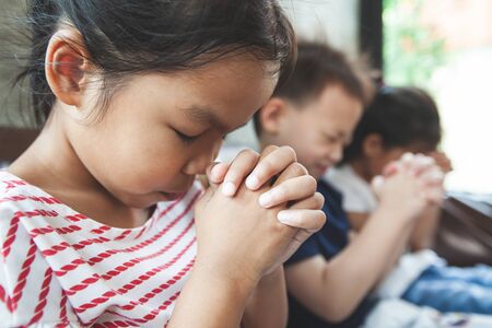 Asian child girl wearing protection mask praying for a new day freedom to coronavirus Covid-19 and stay at home quarantine from the coronavirus Covid-19 and air pollution pm2.5.の写真素材