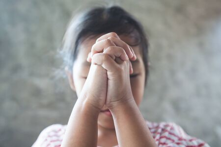 Asian child girl praying for a new day freedom to coronavirus Covid-19 and stay at home quarantine from the coronavirus Covid-19 and air pollution pm2.5.の写真素材