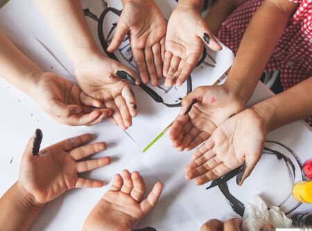 Group of children prepare their hands for painted with watercolor to play togetherの写真素材