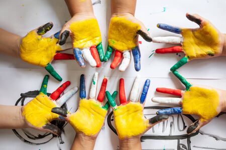 Children's hands in colorful paintedの写真素材