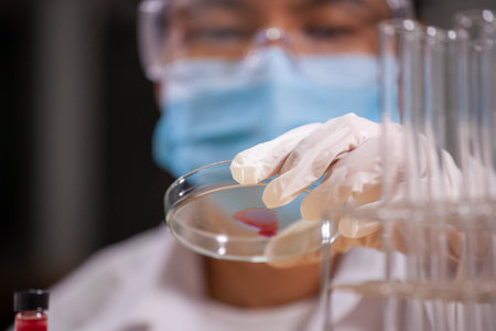 Asian scientist is analysis blood and research chemical test in a laboratory.