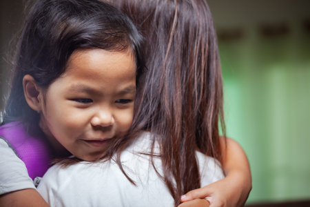 Asian child girl is hugging her mother and getting ready for school.
