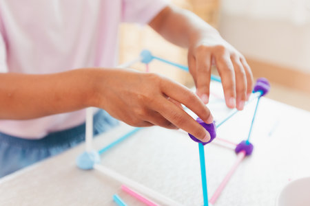 Cute asian child girl playing and creating with playdough and straws.の写真素材