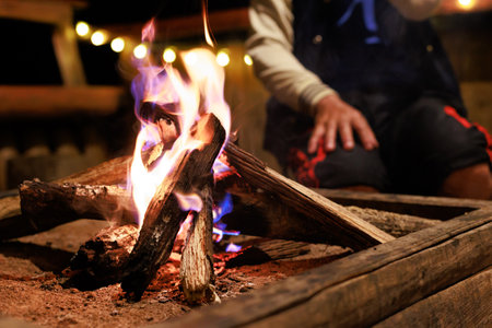 Close-up of flames from bonfire wood burning in dark in night campfireの写真素材