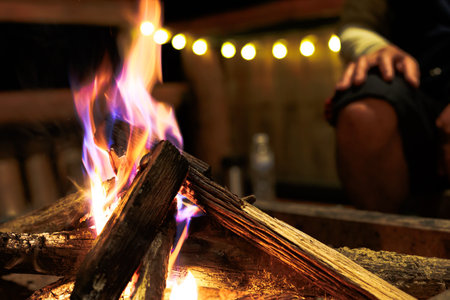 Close-up of flames from bonfire wood burning in dark in night campfireの写真素材