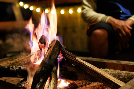 Close-up of flames from bonfire wood burning in dark in night campfireの写真素材