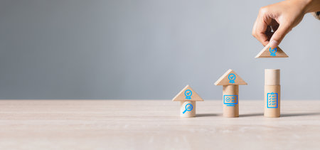 Hand arranging wooden block stacking as arrow up with a quality warranty icon. Business growth with quality and guarantee product. Success process and development for corporation concept.の写真素材