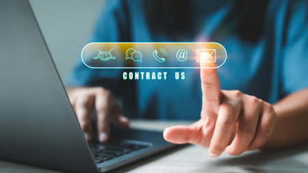 Finger touching virtual screen icons of telephone, mail, chat message and address. Website page customer support hotline contact us people connection e-mail marketing concept.の写真素材