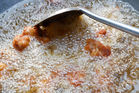 Fried chicken in oil in a large panの写真素材