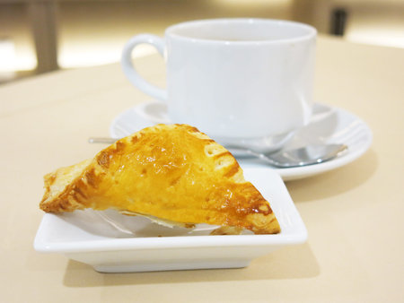 pie with tea on living room background.