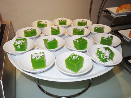Green coconut sweet pudding on white plate.の写真素材