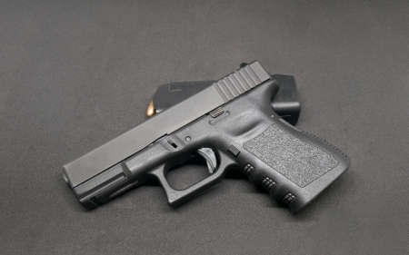 9mm Pistol and loaded magazine on black backgroundの写真素材