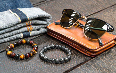 Men accessories, leather and denim fashion set on wood floor