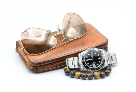 Men accessories, leather wallet, stainless watch, sunglass, bracelet on white backgroundの写真素材