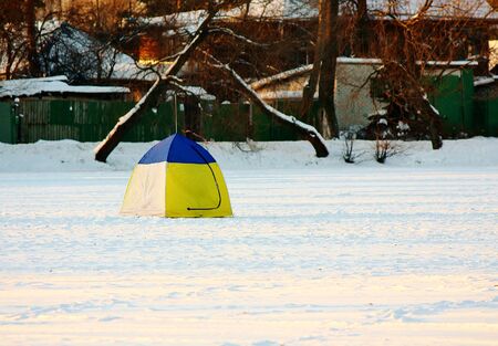 Tent of fisherman on lake in winterの写真素材