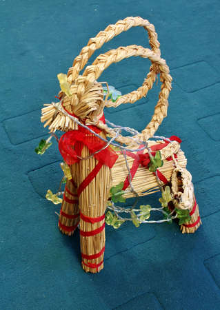 Straw toy with a Christmas wreath on the floor of the roomの写真素材
