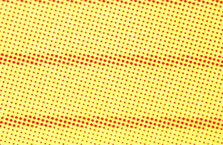 Dots, stripes and lines of white and red color on a light yellow backgroundの写真素材