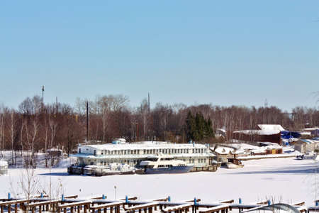 Yachts, boats and river passenger ships in the snow on a winter dockのeditorial素材