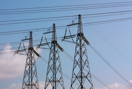 Ìasts and wires of power line on the background of blue sky