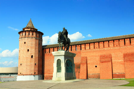Bronze statue of a medieval Russian warrior in armor on a horse on the background of the fortress wallのeditorial素材