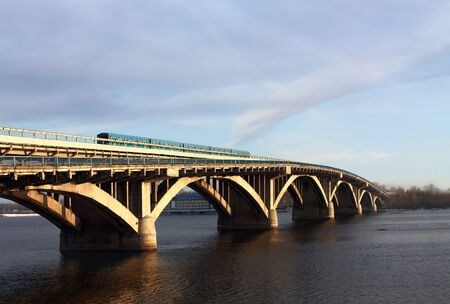Bridge with subway line and highways across the great river in the early morningの写真素材