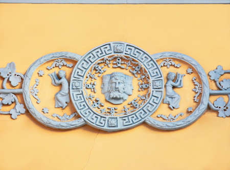 Fretwork in the form of an ancient family crest on the wall of a historic mansionの写真素材